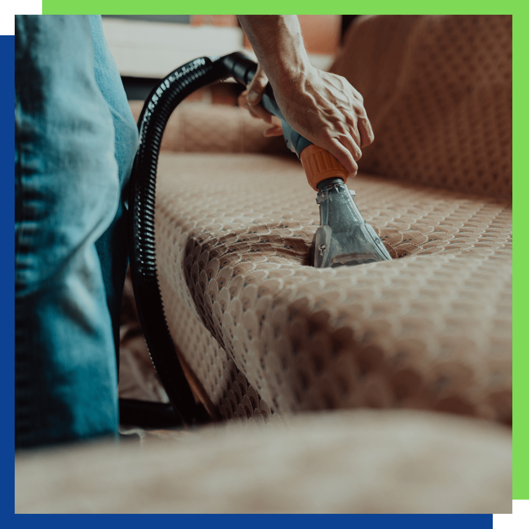 Person steam cleaning upholstery