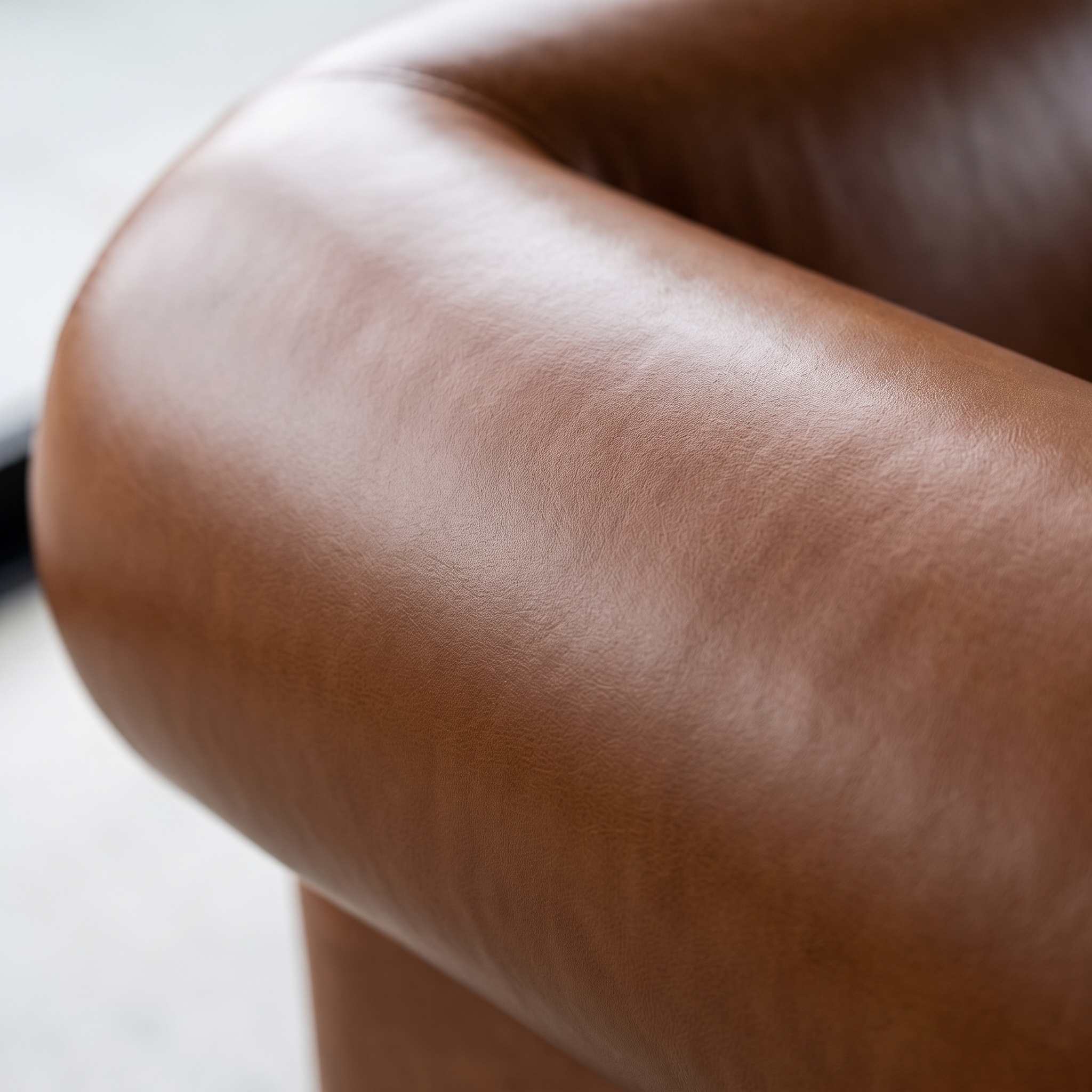 Close-up of smooth, repaired leather on a couch armrest